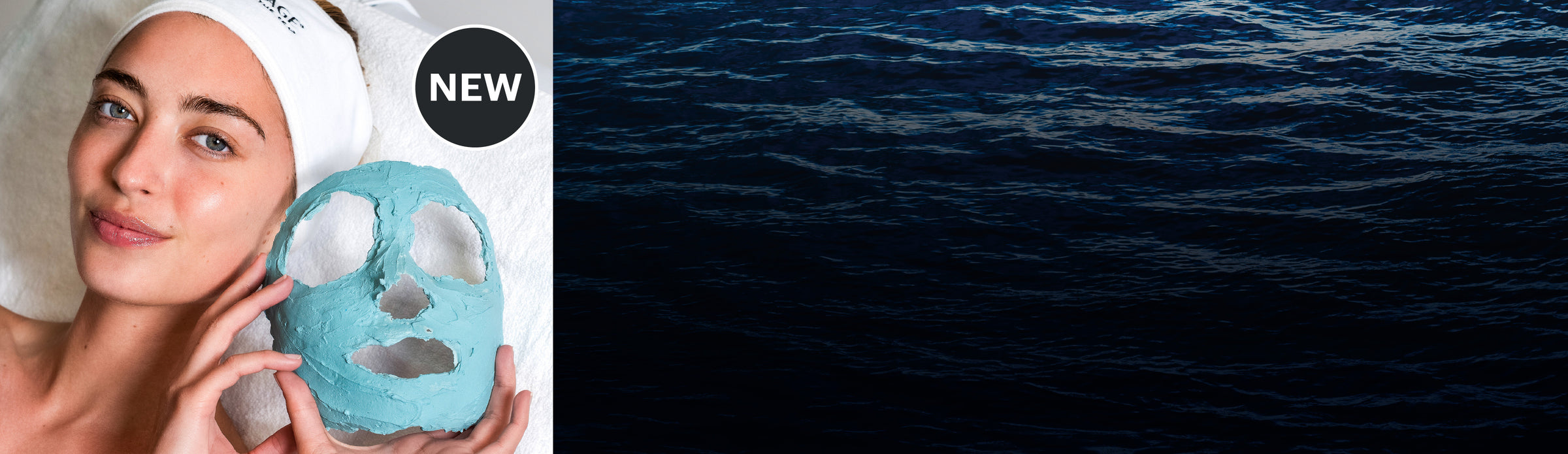 Woman holding a blue facial mask with a white towel on her head, next to a dark ocean background.